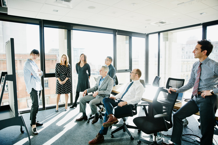 Group of businesspeople discussing project during team meeting in conference room